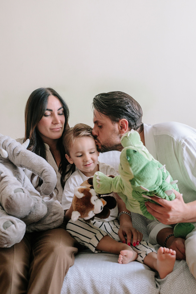 Young Parents Playing with Son at Home 